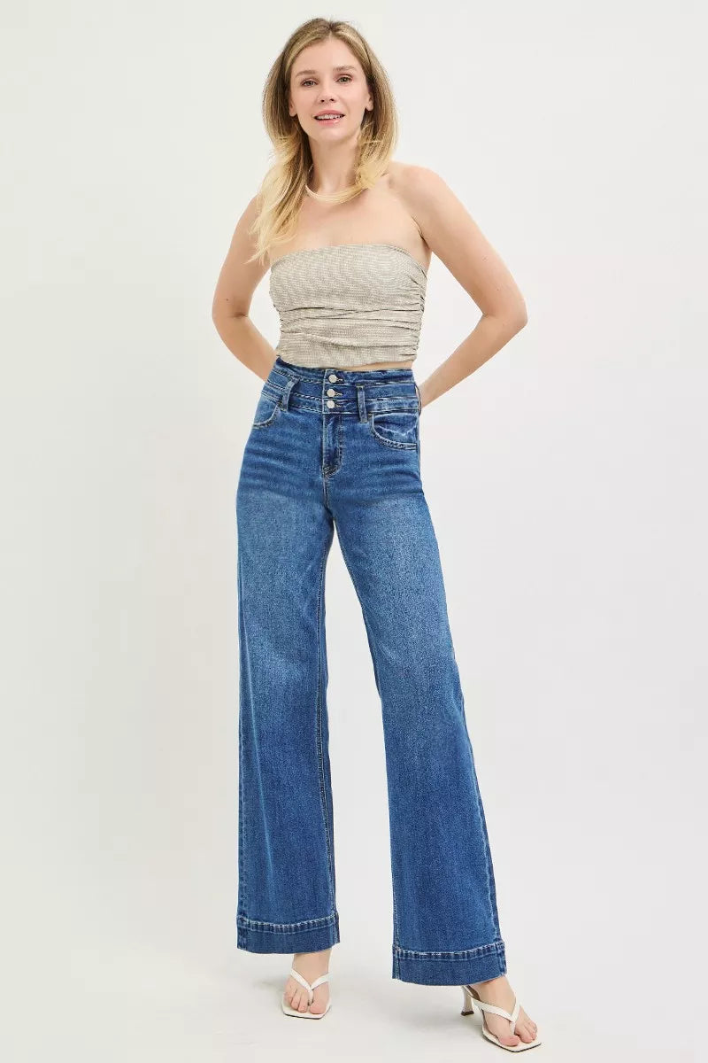 Dark wash Risen high-rise wide-leg jeans with wide band and detailed stitching, styled for a trendy casual look.