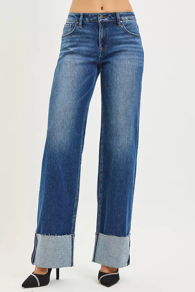 Dark denim RISEN mid-rise wide straight jeans with wide cuff, shown on a model. Trendy and comfortable fit for casual wear.