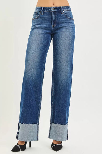 Dark denim RISEN mid-rise wide straight jeans with wide cuff, shown on a model. Trendy and comfortable fit for casual wear.