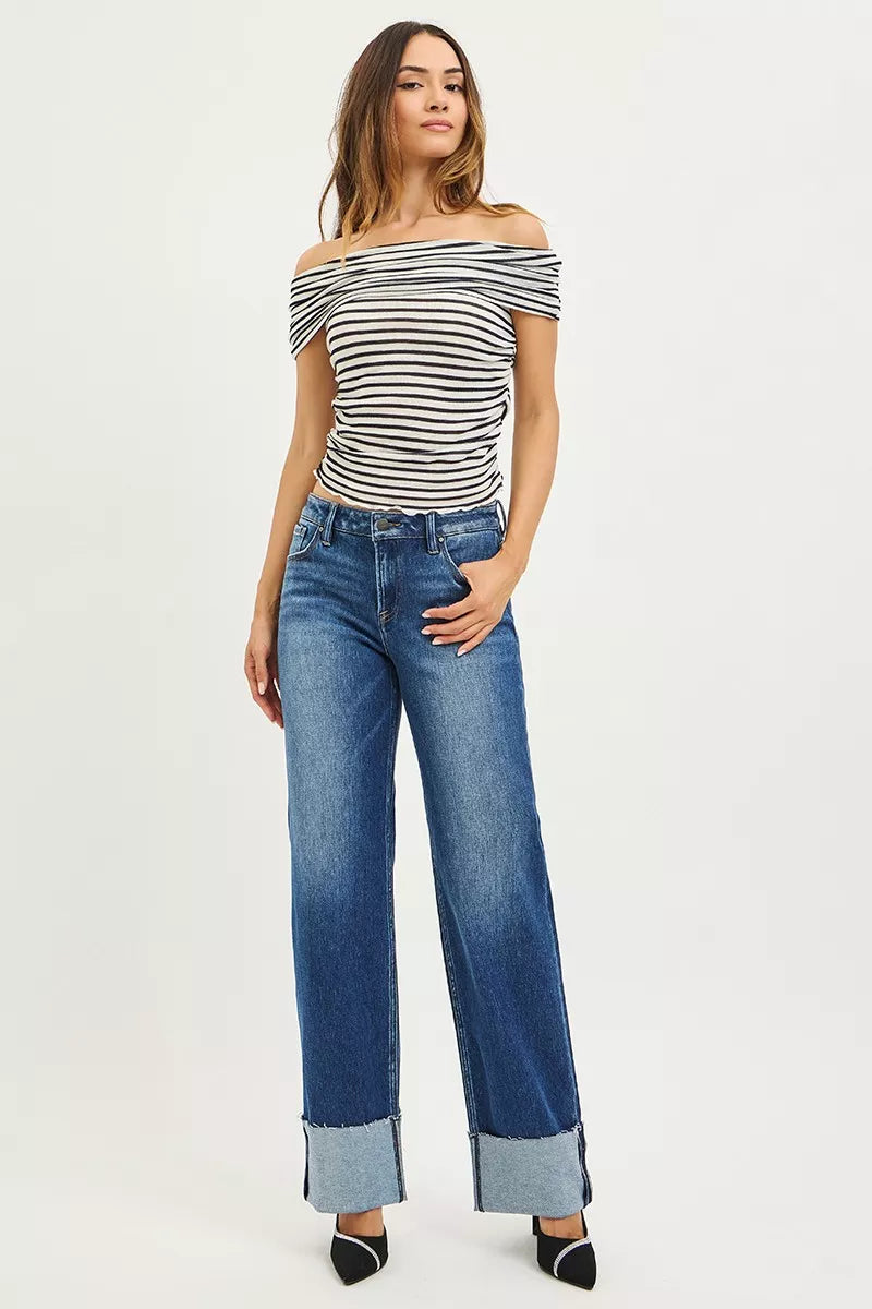 Dark wash Risen mid-rise wide straight jeans by Trendsi with wide cuff, showcasing relaxed fit and stylish denim details.