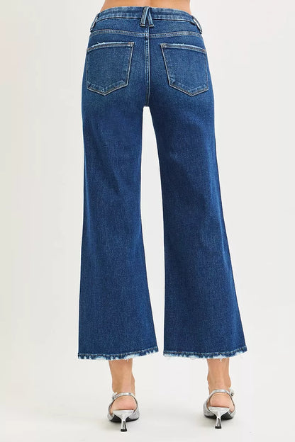 Dark wash Risen high-rise crop jeans with wide legs and tummy control, featuring 4-way stretch for comfortable wear.