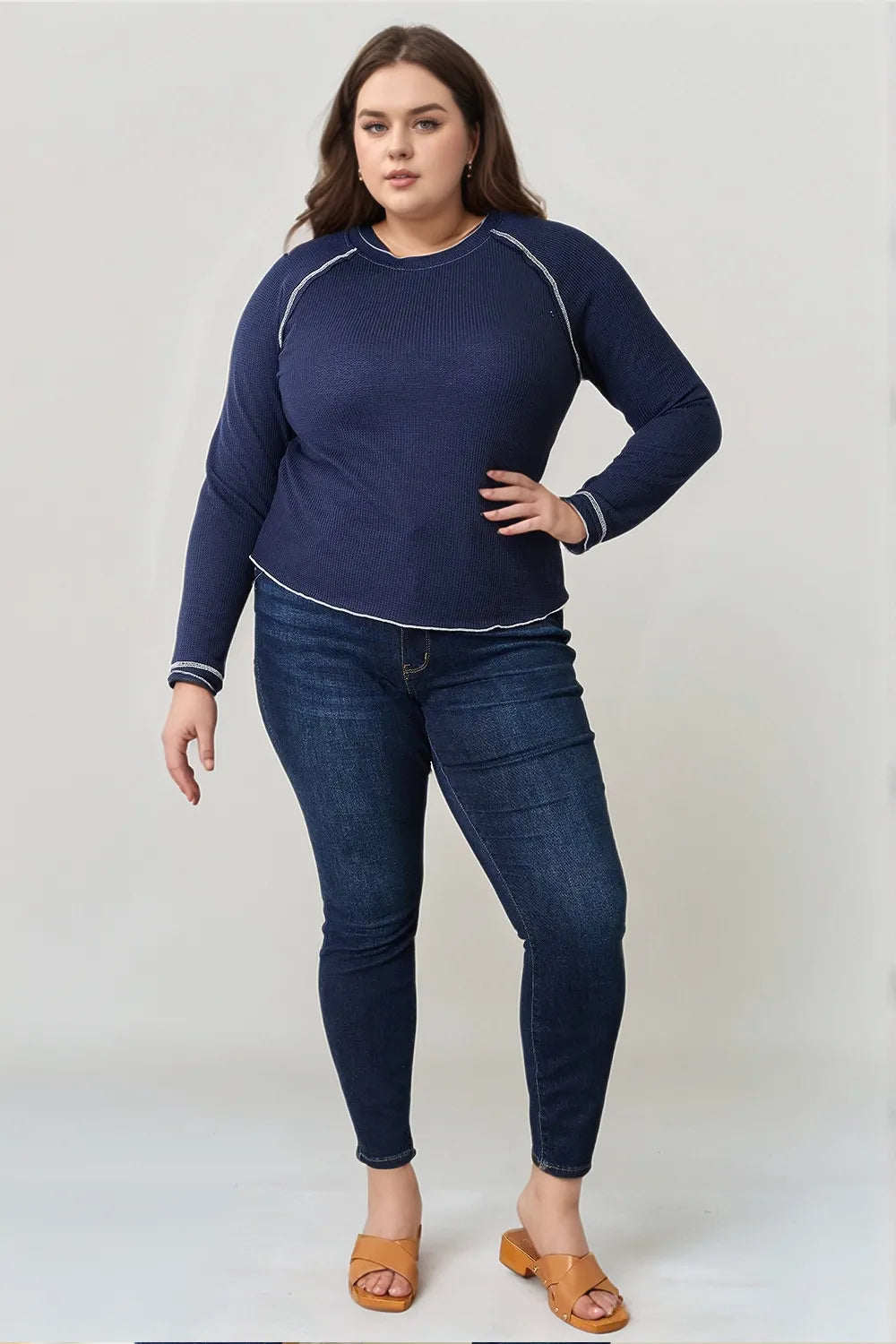 Dark blue Basic Bae long raglan sleeve round neck top by Trendsi, showing the casual, comfortable fit and stylish design.