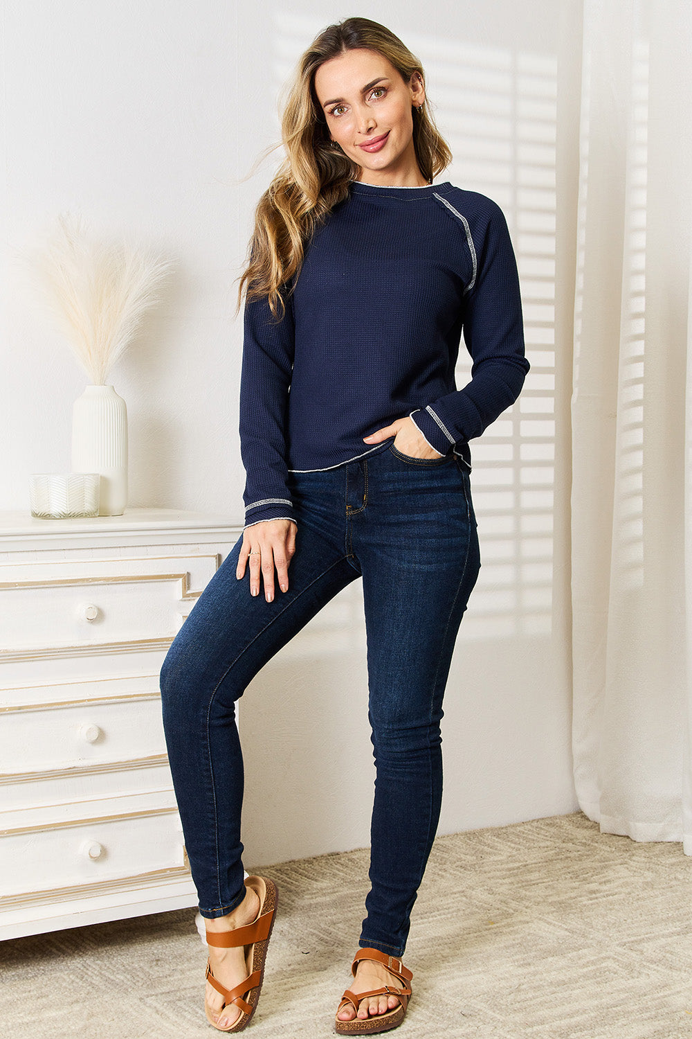 Dark blue Basic Bae long raglan sleeve round neck top by Trendsi, shown on a model, casual style, lightweight fabric.