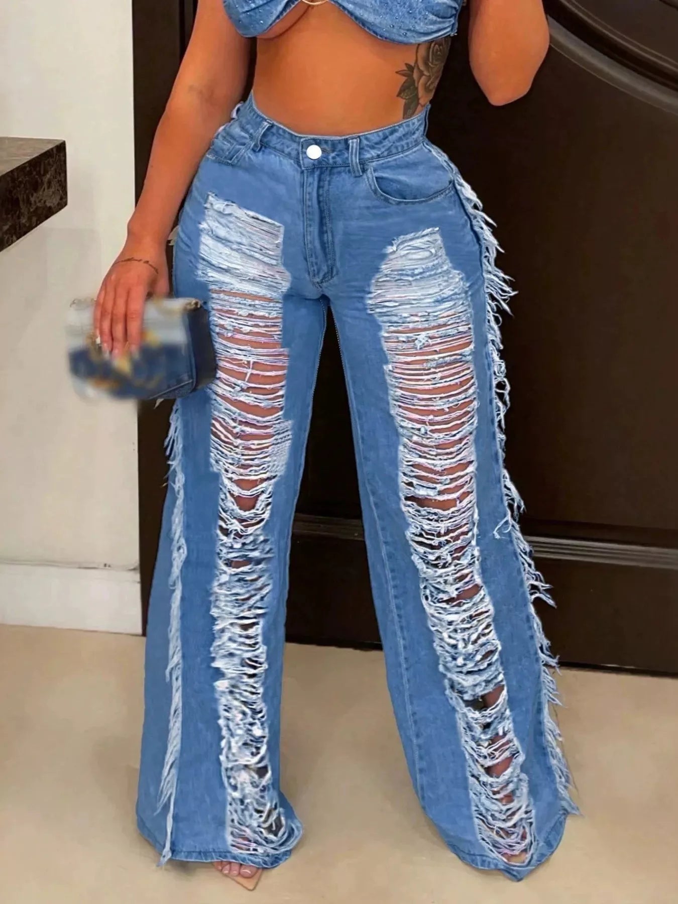 Dark blue distressed wide-leg jeans by Trendsi, showcasing a relaxed fit with frayed details and a casual, trendy style.