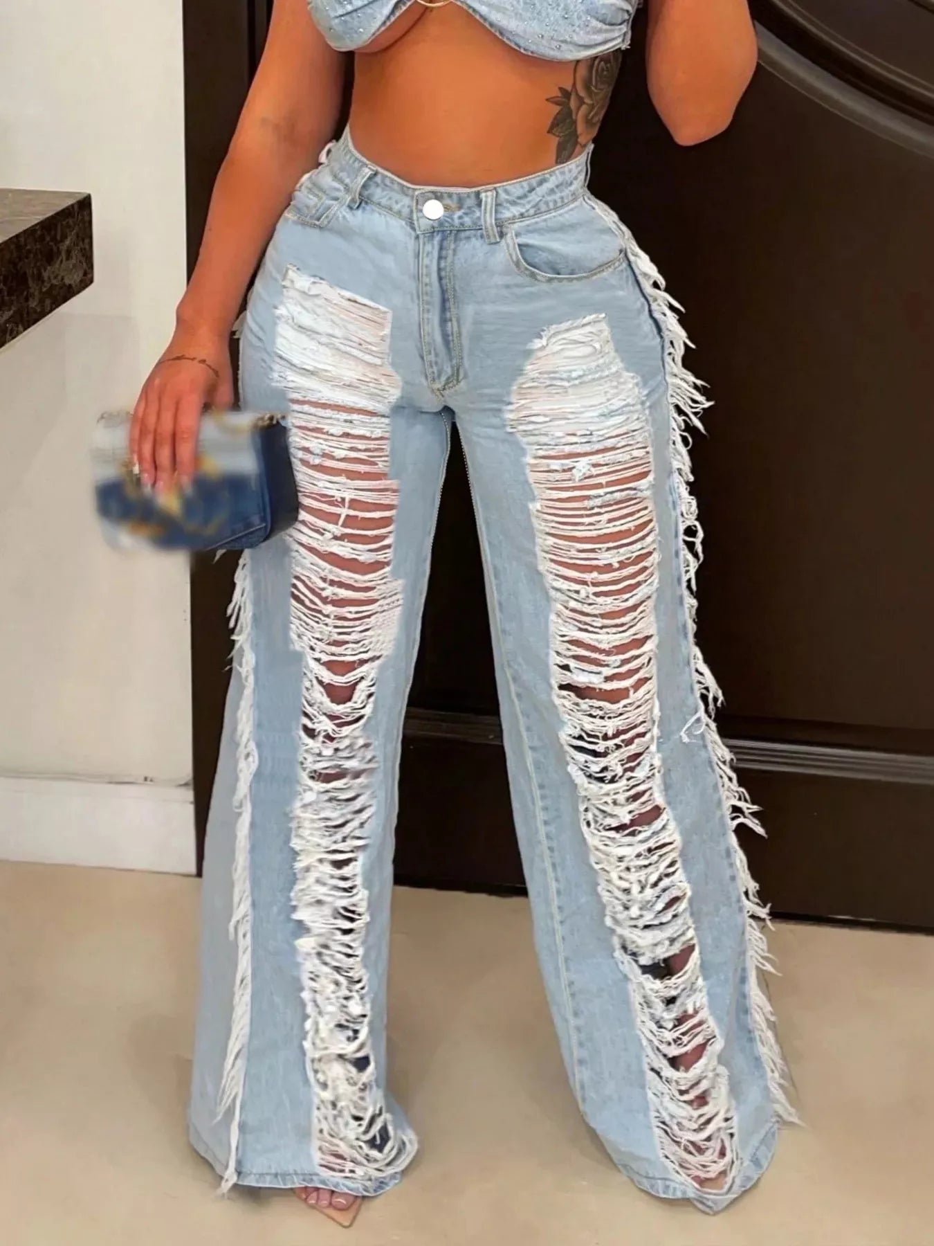 Dark blue distressed wide-leg jeans from Trendsi, featuring a relaxed fit and frayed hem, displayed on a plain background.