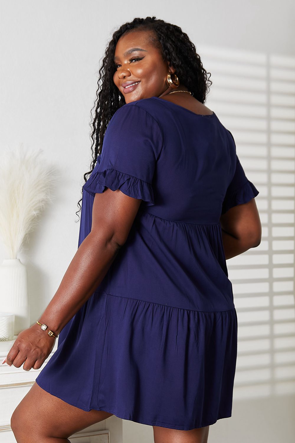 Dark blue Mandy V-neck flounce sleeve tiered dress by Trendsi, featuring flowy layers and a stylish V-neck design.