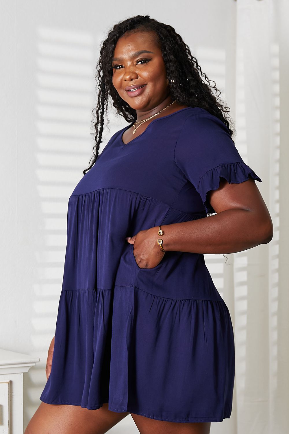 Dark blue Mandy V-neck flounce sleeve tiered dress from Trendsi, featuring a stylish V-neck and flowy layered skirt.