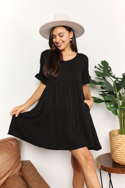 Dark blue Mandy V-Neck Flounce Sleeve Tiered Dress by Trendsi, featuring a V-neckline and layered tiered skirt.