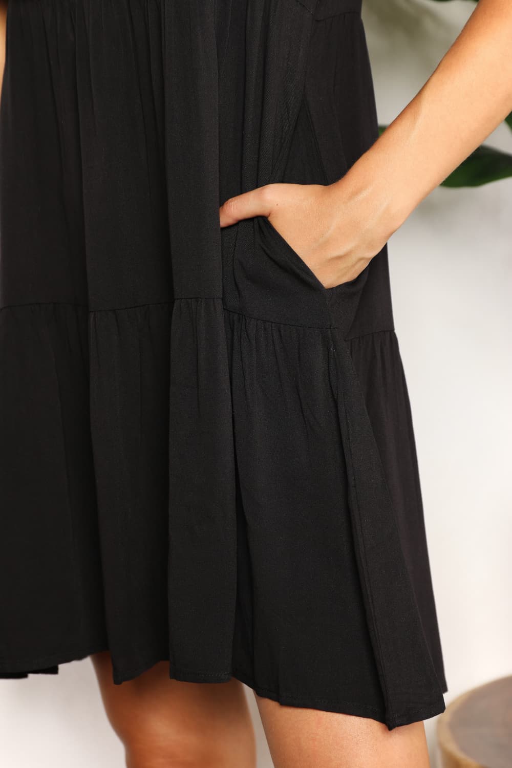 Dark blue Mandy V-neck flounce sleeve tiered dress from Trendsi, showing the feminine V-neck design and layered skirt.