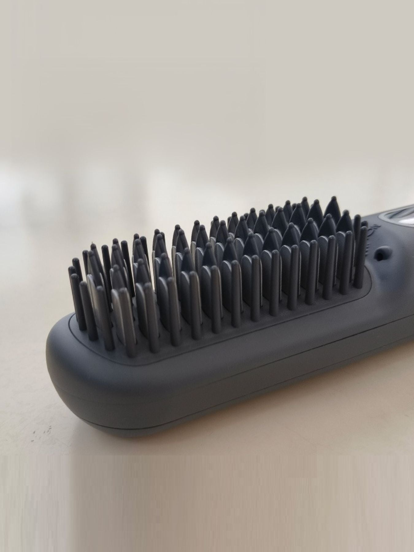 Dark gray Trendsi heated straightening comb with ergonomic handle, designed for smooth, sleek hair styling.