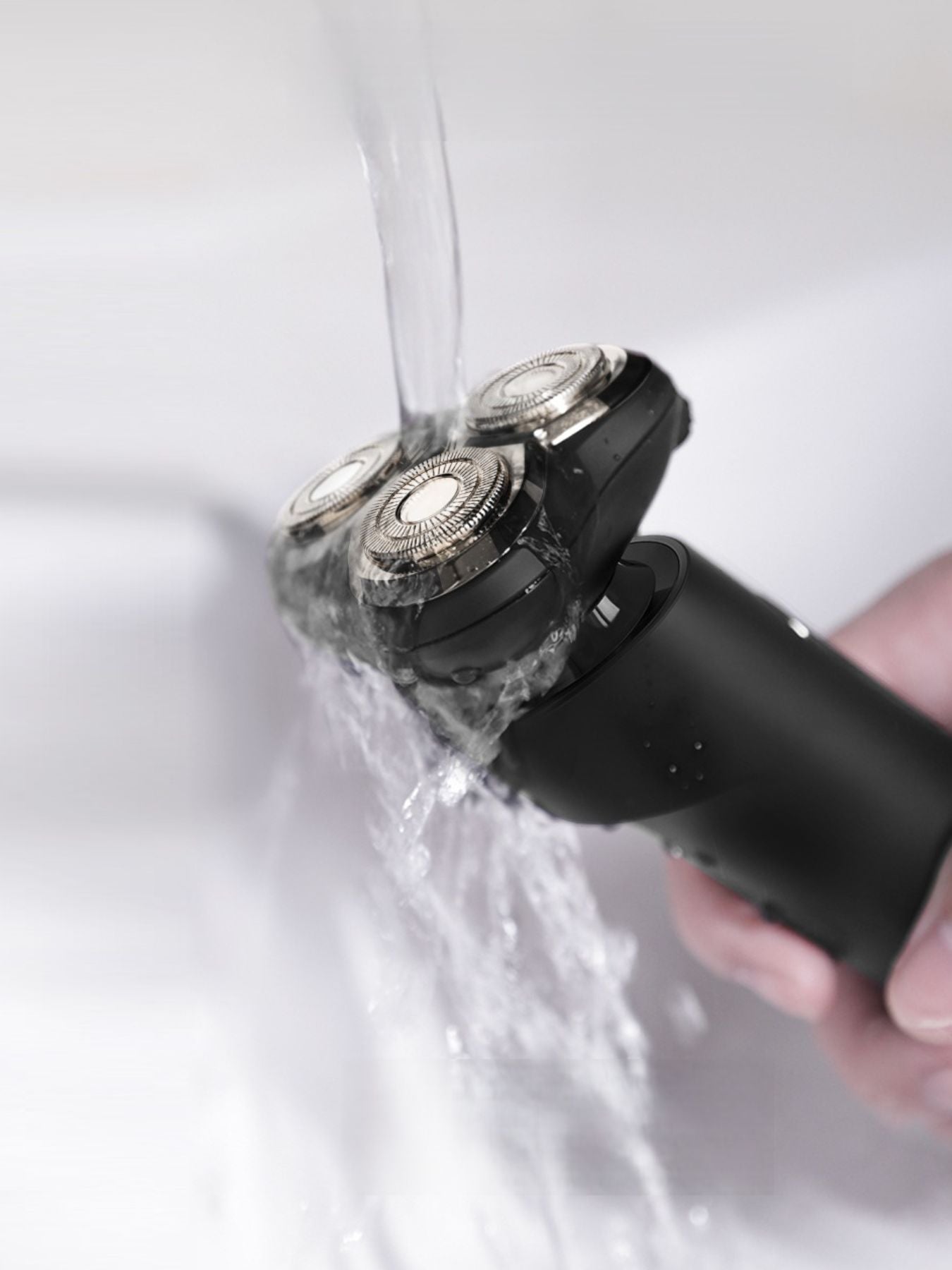 Dark gray rechargeable rotary shaver by Trendsi with multiple rotary blades and ergonomic handle for a close, comfortable shave.