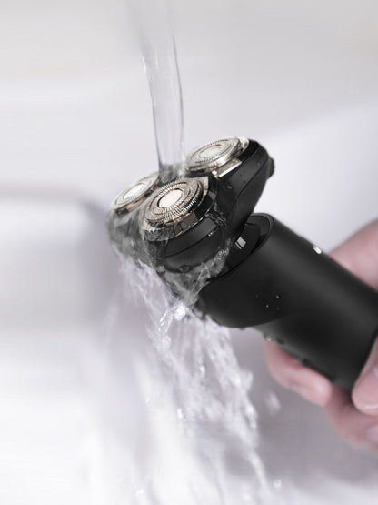 Dark gray rechargeable rotary shaver by Trendsi with multiple rotary blades and ergonomic handle for a close, comfortable shave.