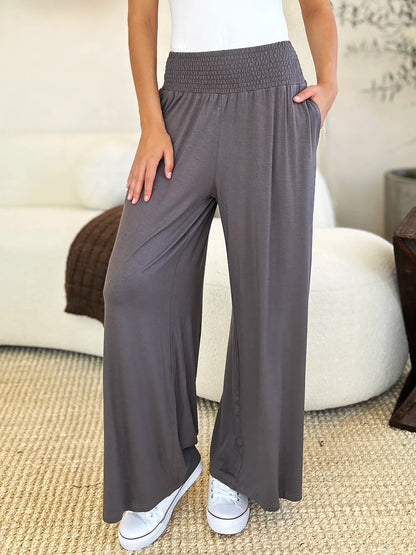 Dark gray Basic Bae full-size smocked wide waistband wide-leg pants by Trendsi, showcasing relaxed fit and comfortable style.