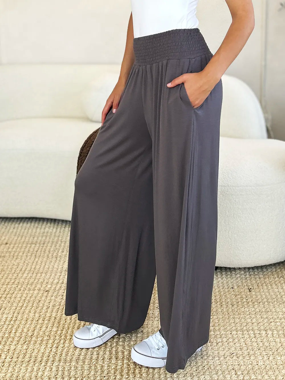 Dark gray Basic Bae full-size smocked wide waistband wide-leg pants by Trendsi, showing relaxed fit and comfortable style.