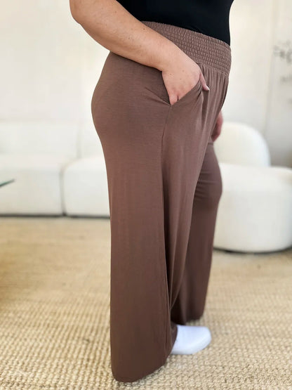 Dark gray Trendsi Basic Bae full-size smocked wide waistband wide-leg pants laid flat on a white background.