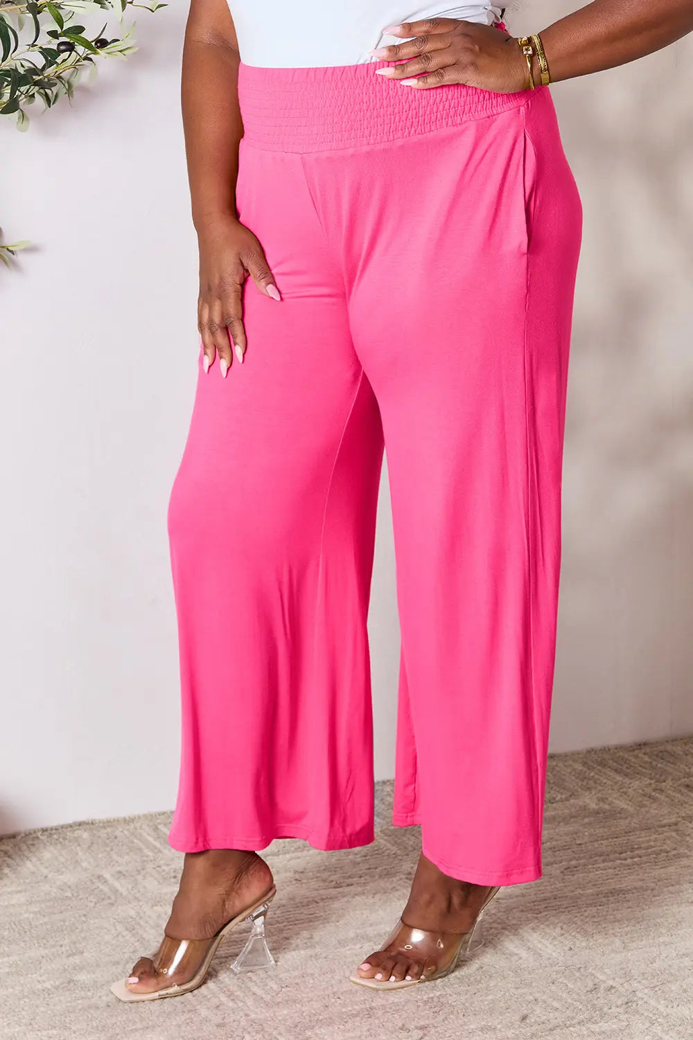 Dark gray Trendsi Basic Bae full-size smocked wide waistband wide-leg pants laid flat showing relaxed fit and soft fabric.