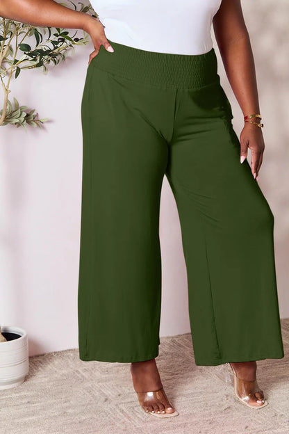 Dark gray Basic Bae full-size smocked wide waistband wide-leg pants by Trendsi, shown on a model with relaxed fit and soft fabric.