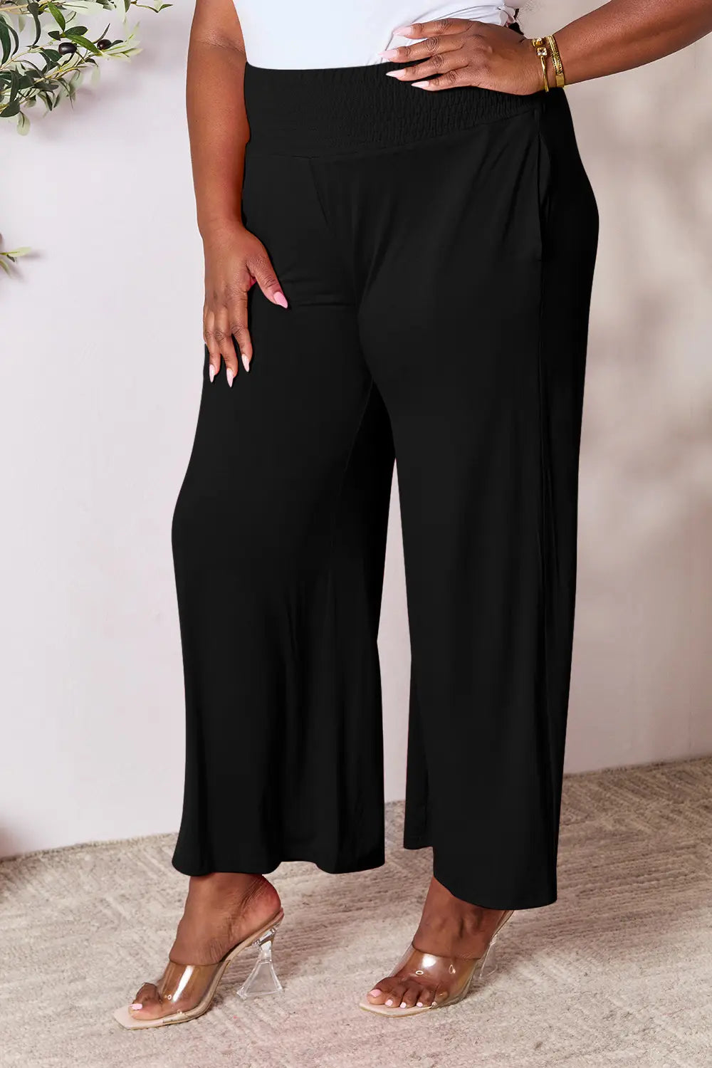 Dark gray Trendsi Basic Bae full-size wide-leg pants with smocked wide waistband and relaxed fit, styled for casual wear.