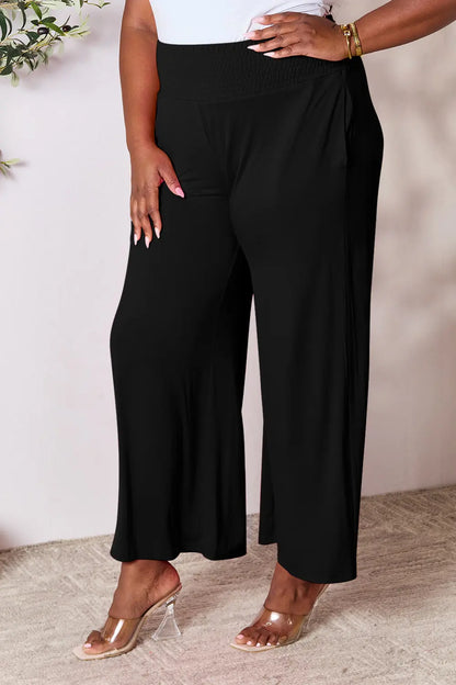 Dark gray Trendsi Basic Bae full-size wide-leg pants with smocked wide waistband and relaxed fit, styled for casual wear.