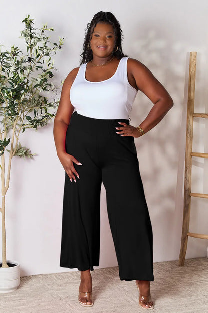 Dark gray Trendsi Basic Bae full-size smocked wide waistband wide-leg pants laid flat on a white background.
