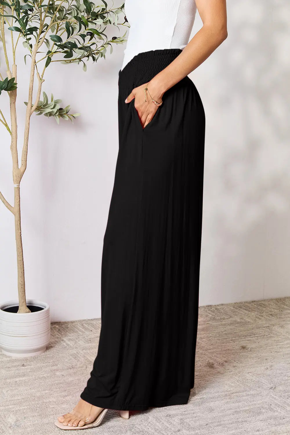 Dark gray Trendsi Basic Bae full-size smocked wide waistband wide-leg pants displayed flat with relaxed fit and soft fabric.