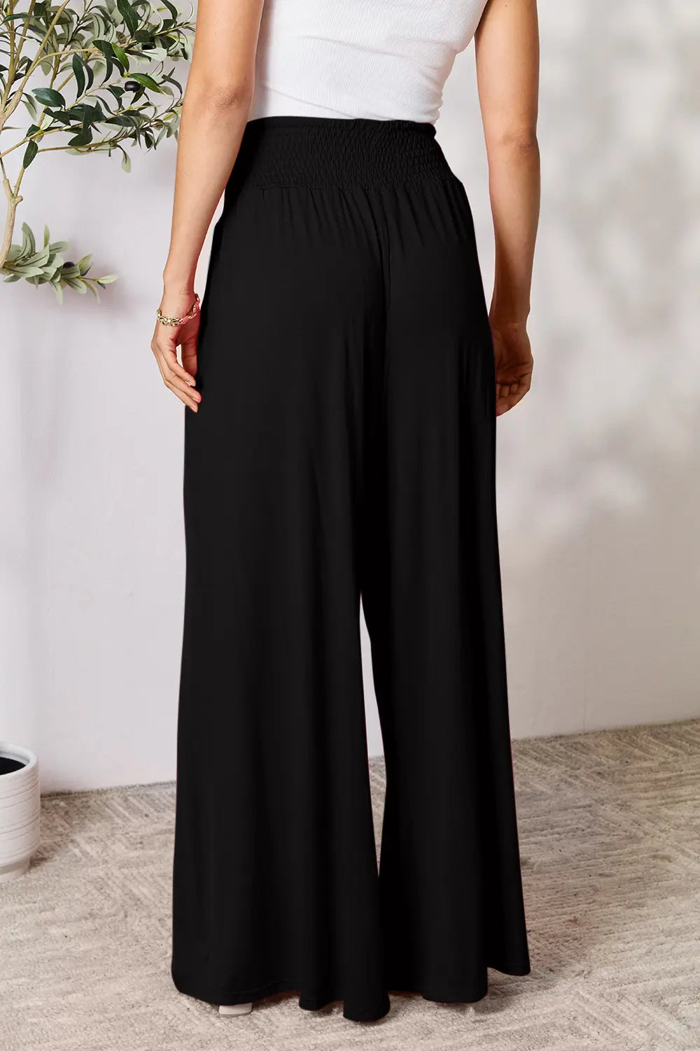 Dark gray Basic Bae full-size smocked wide waistband wide-leg pants by Trendsi, shown flat with relaxed fit and flowy fabric.