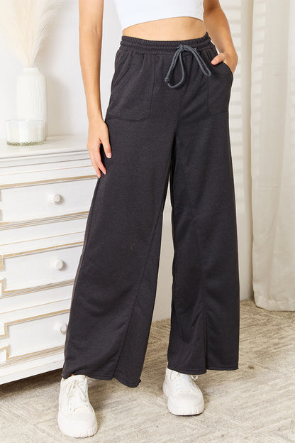 Dark gray Basic Bae wide leg pocketed pants by Trendsi, featuring a relaxed fit and side pockets.