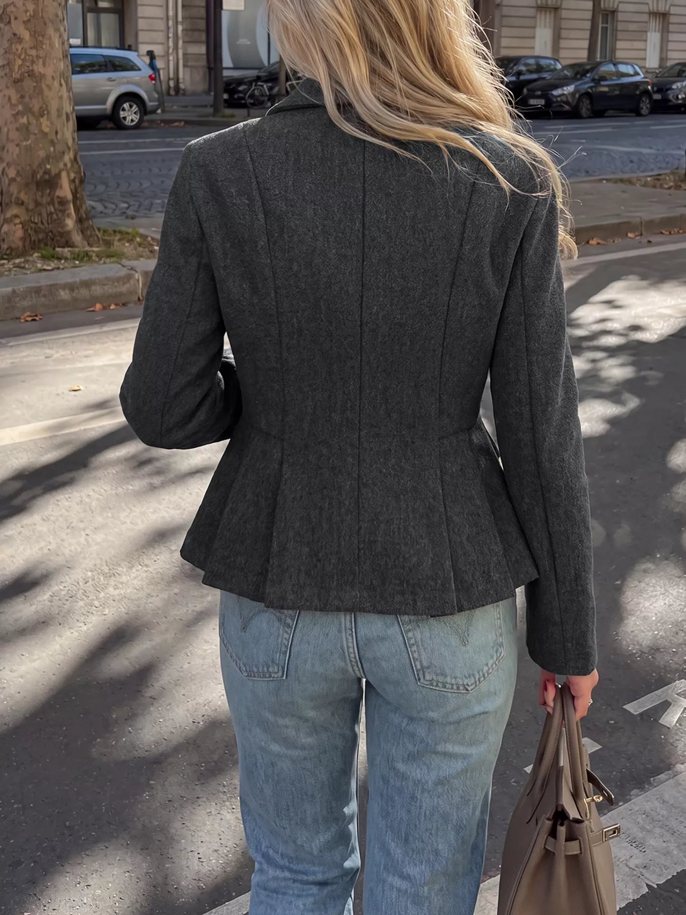 Dark gray double-breasted peplum blazer from Trendsi, tailored fit with structured lapels and button closures, styled on a model.