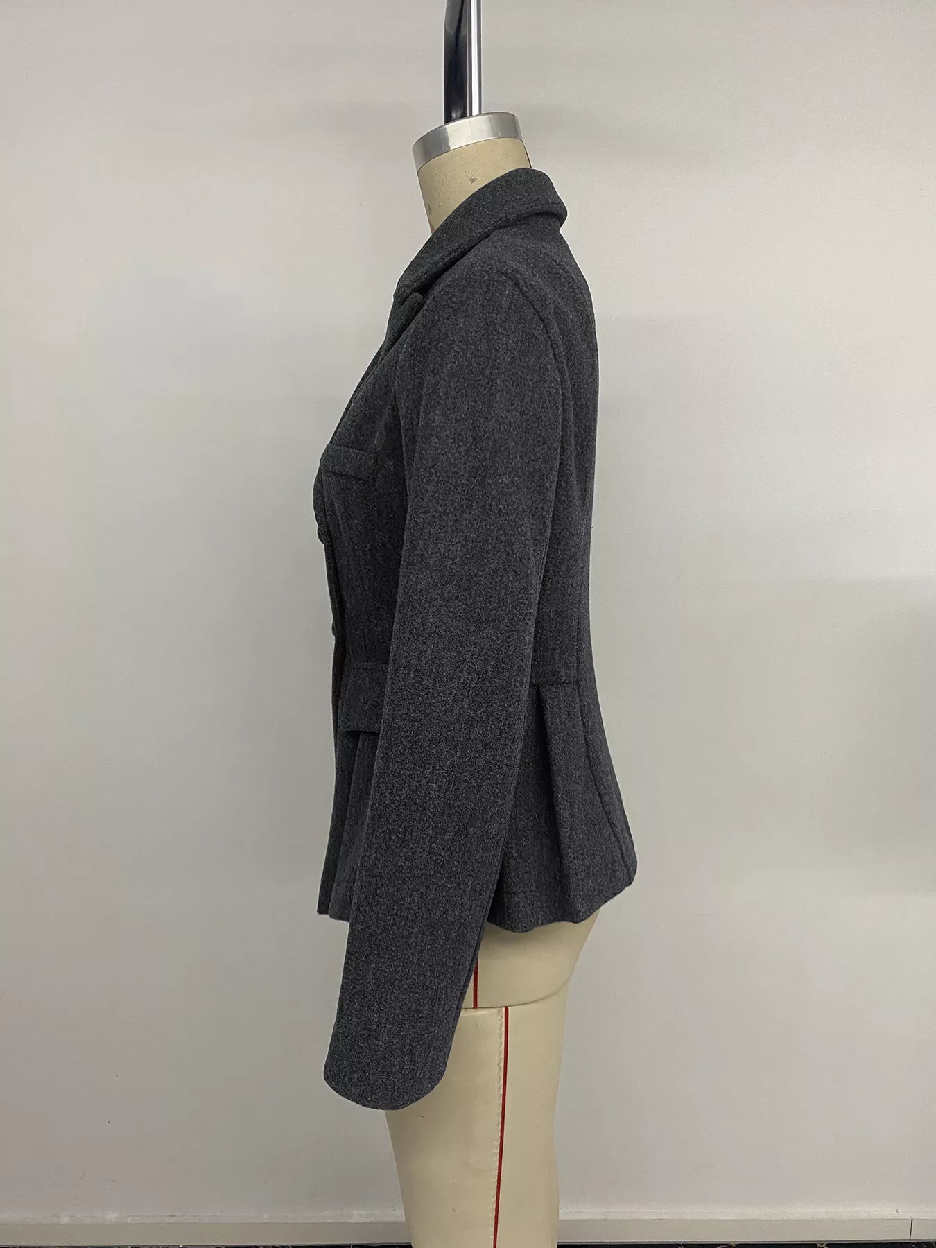 Dark gray double-breasted peplum blazer from Trendsi, styled with a tailored fit and structured lapels, shown on a mannequin.