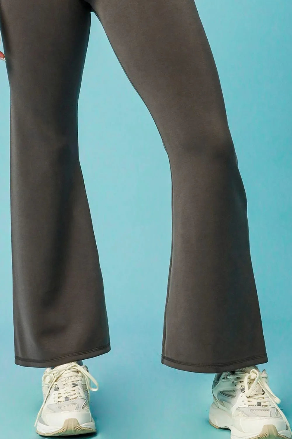 Dark gray high-waisted flare leggings by Umgee for women, shown on a model, featuring a snug fit and stylish flare at the ankles.