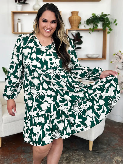 Dark green double take full-size printed ruffle hem dress with pockets by Trendsi, featuring a stylish ruffle detail and comfortable fit.