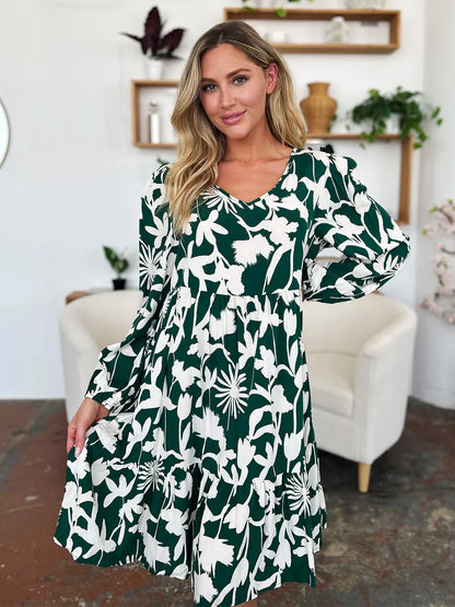 Dark green Trendsi Double Take full-size dress with printed fabric, ruffle hem, and a convenient side pocket displayed in the image.