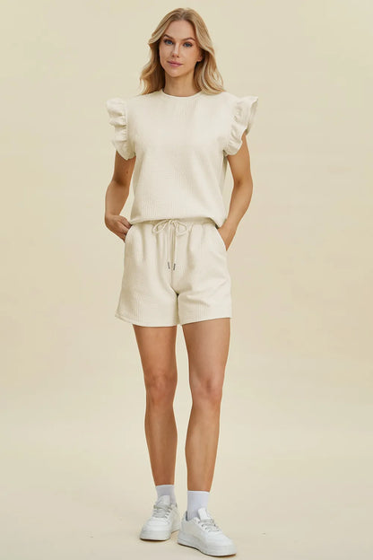 Dark green Trendsi double take full-size textured round neck top with ruffle sleeves and matching shorts set on a model.