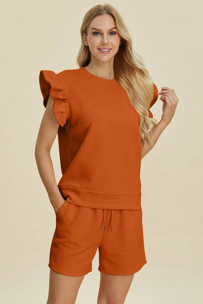 Dark green Trendsi double take full-size textured round neck top with ruffle sleeves and matching shorts set, casual and stylish.
