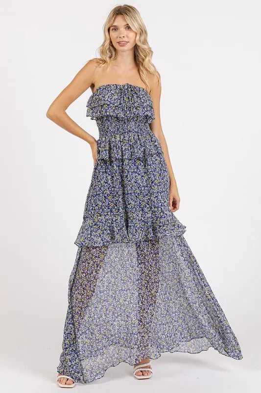 Dark navy ruffled smocked floral halter neck maxi dress by Mittoshop, styled with flowing fabric and floral pattern.