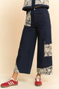 Dark wash Davi & Dani lace applique wide-leg jeans featuring decorative lace details and a relaxed fit.