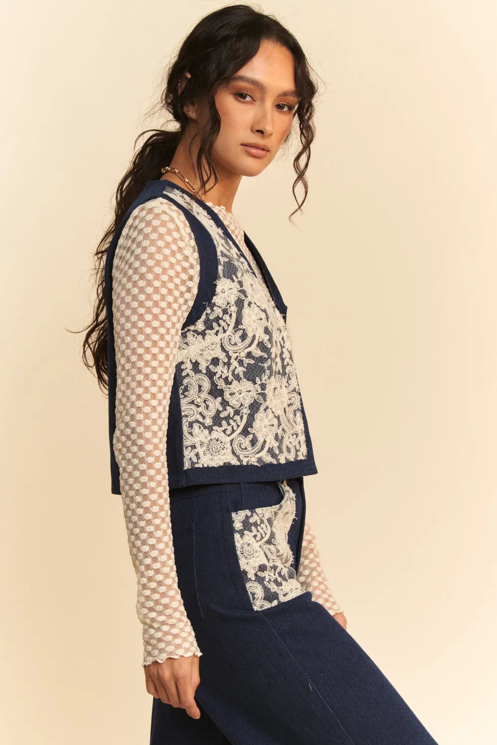 Dark denim open front vest with lace patch details from Davi & Dani, styled with a casual, trendy look.