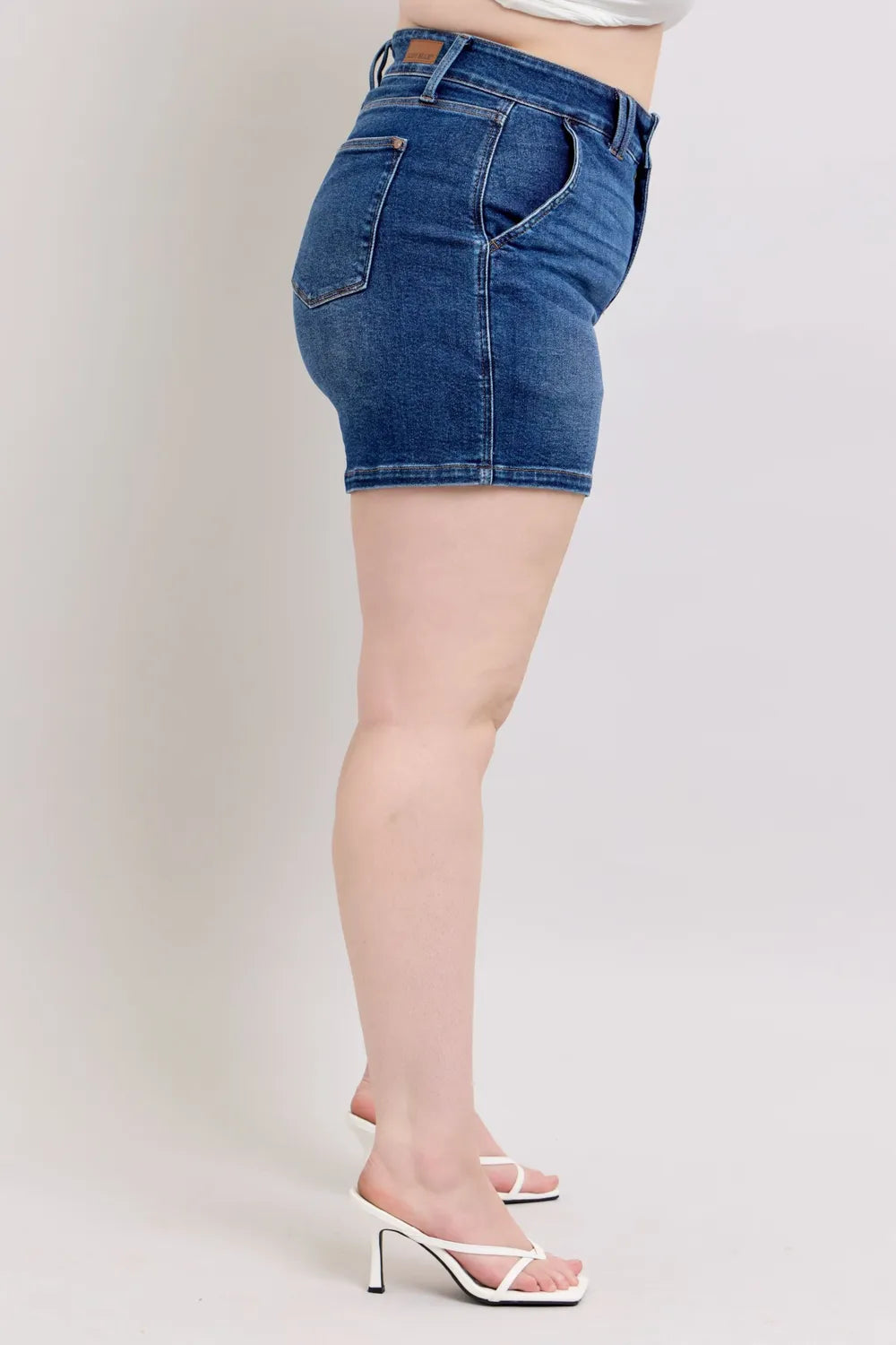 Plus size Judy Blue denim shorts with double button waistband, dark wash, and relaxed fit, designed by Trendsi.