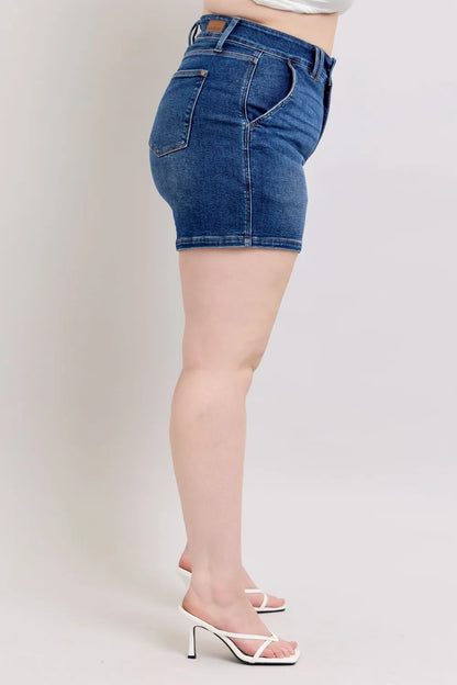 Plus size Judy Blue denim shorts with double button waistband, dark wash, and relaxed fit, designed by Trendsi.