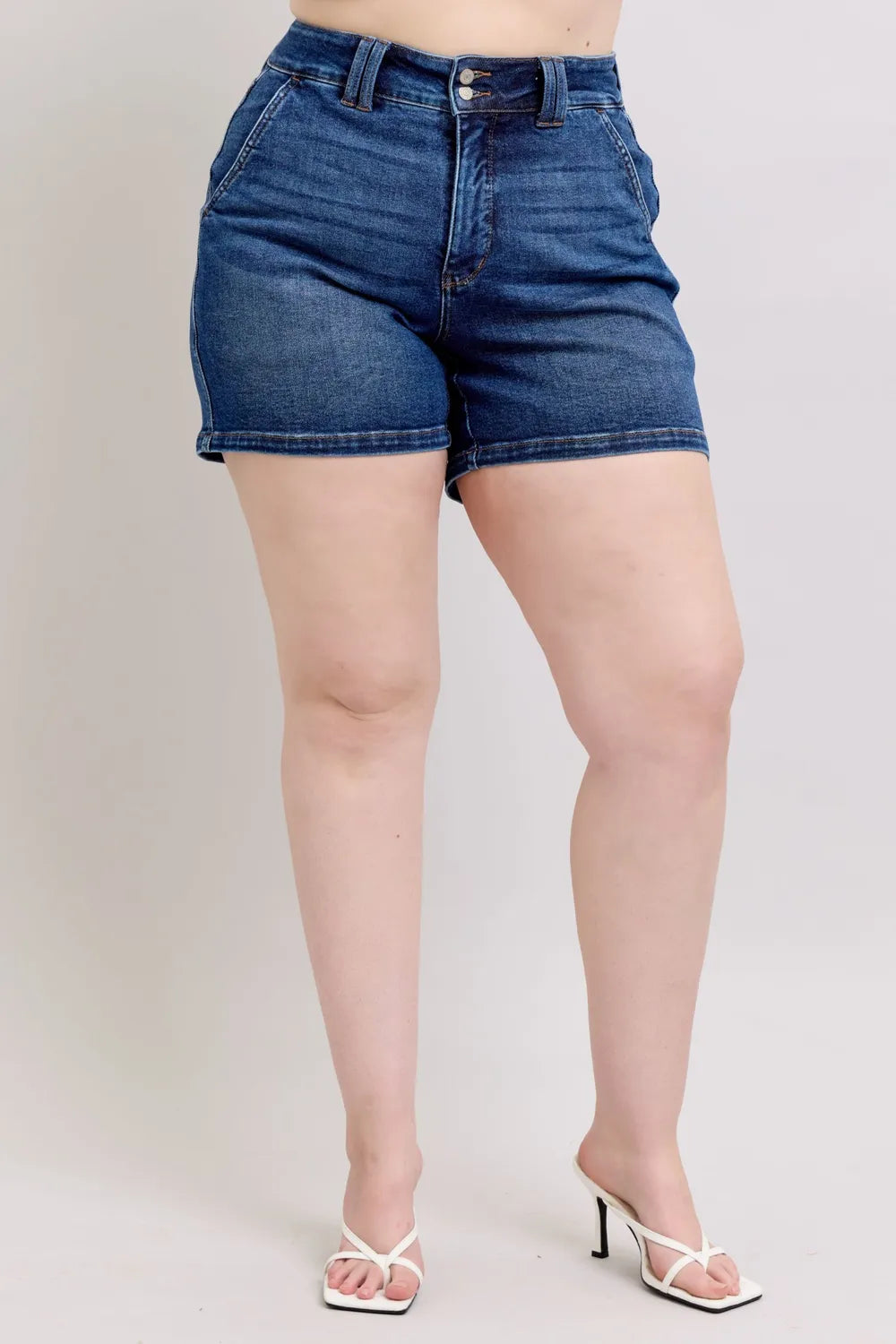 Plus size Judy Blue denim shorts with double button waistband, dark wash, and classic five-pocket design.