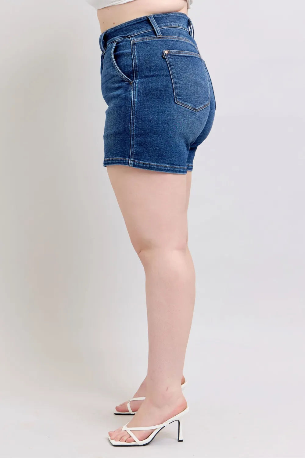 Plus size Judy Blue denim shorts with double button waistband, featuring dark wash and classic five-pocket design.
