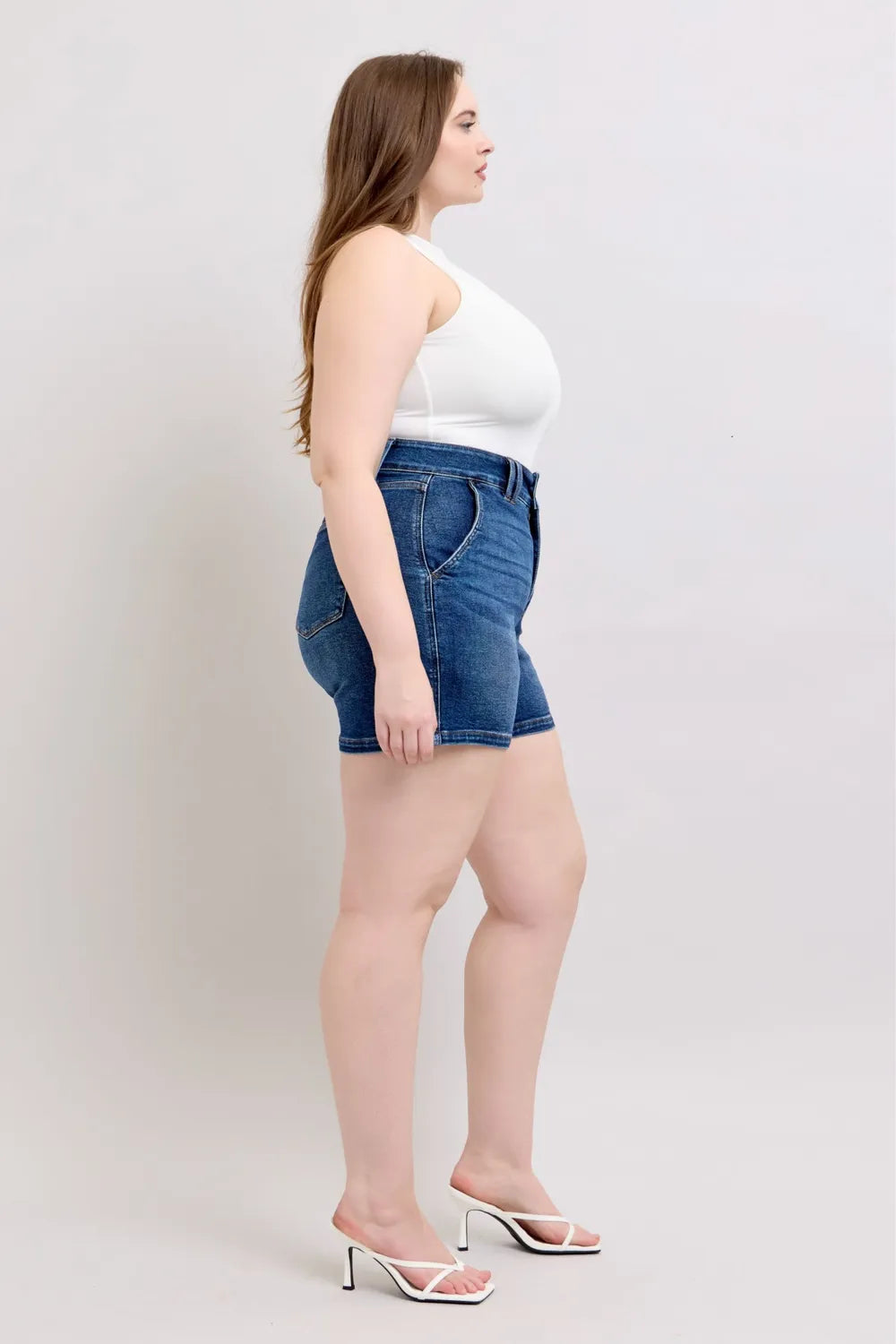 Dark blue Judy Blue plus size denim shorts with double button waistband and front pockets, stylish and comfortable for casual wear.