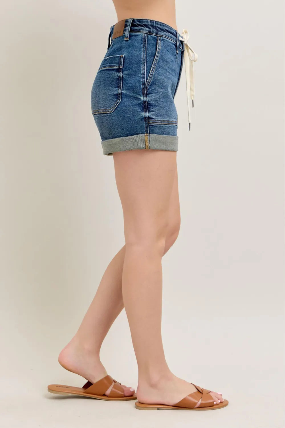 Plus size Judy Blue high-rise cuff denim shorts with a dark wash, showcasing the stylish fit and rolled hem detail.