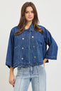 Dark blue RISEN double-breasted flowy cropped denim jacket with long sleeves and classic collar, styled on a model.
