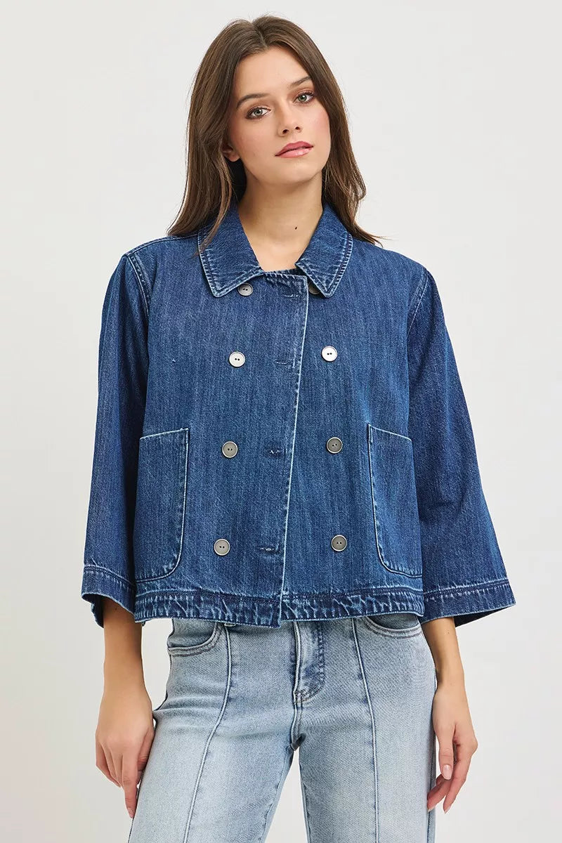 Dark blue RISEN double-breasted flowy cropped denim jacket with long sleeves and structured collar, stylish and versatile for casual wear.