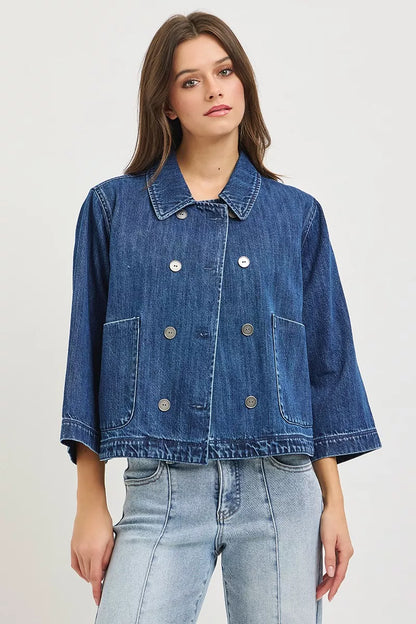 Dark blue RISEN double-breasted flowy cropped denim jacket with long sleeves and structured collar, stylish and versatile for casual wear.