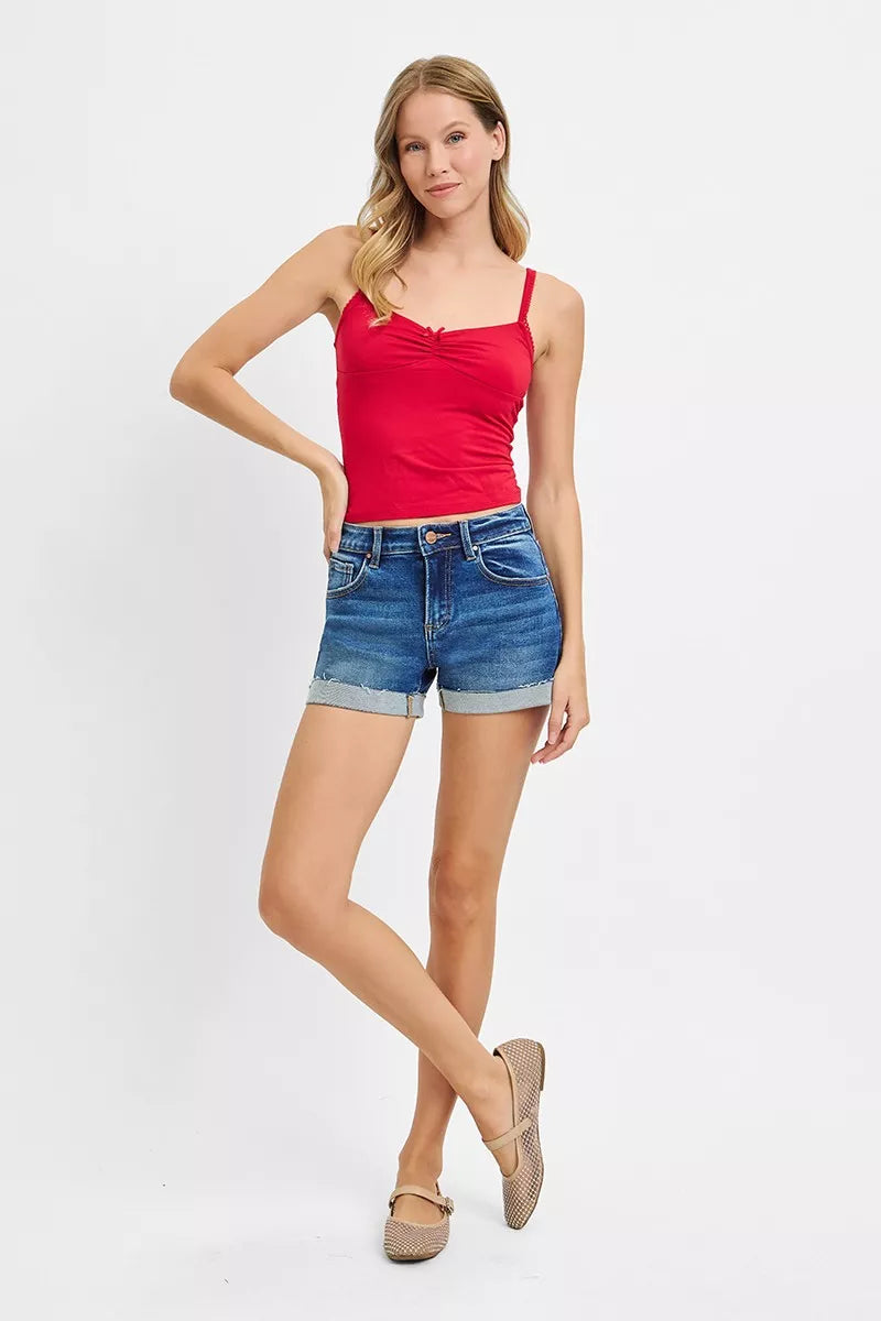 Dark-colored RISEN low rise cuffed shorts by Trendsi, featuring a relaxed fit and rolled-up hem, styled on a mannequin.