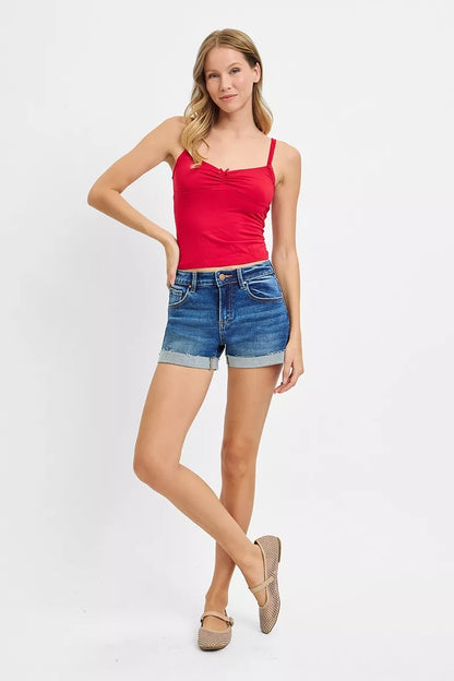 Dark-colored RISEN low rise cuffed shorts by Trendsi, featuring a relaxed fit and rolled-up hem, styled on a mannequin.