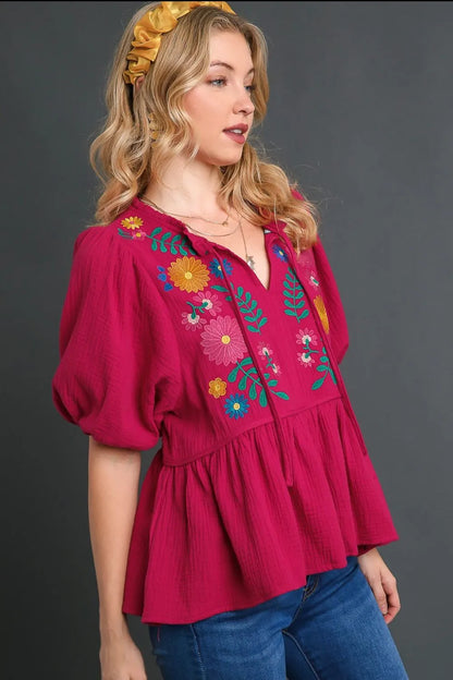 Deep rose plus size Umgee cotton gauze babydoll blouse with floral embroidery, featuring a relaxed fit and feminine design.
