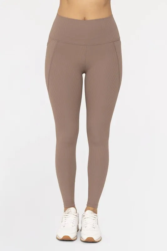 Deep taupe Mono B soft ribbed high-waisted leggings, shown on a model, highlighting their fitted, stretchy design and ribbed texture.
